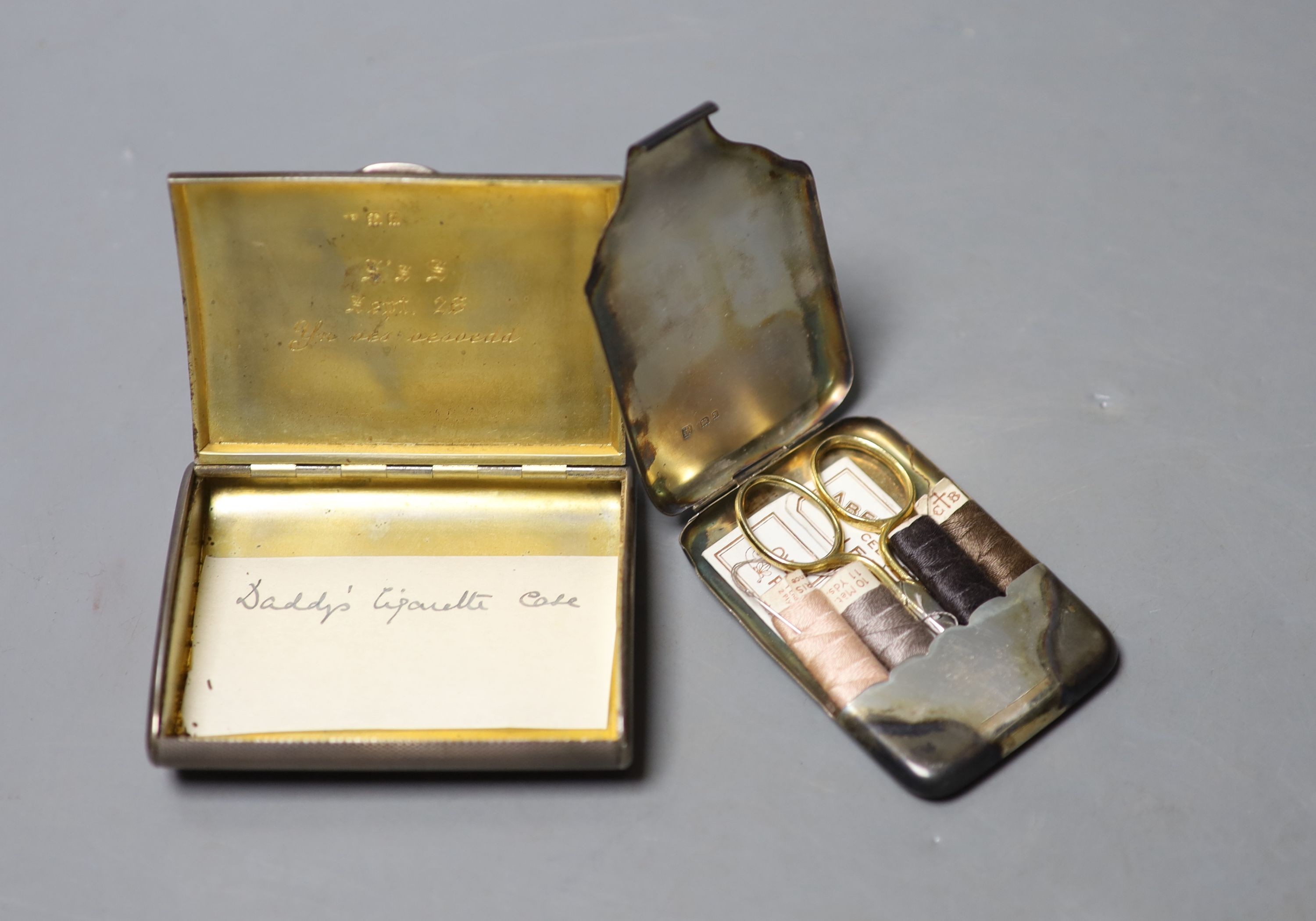 A George V engine turned silver cigarette case, London, 1919, 83mm and a later silver needle case.